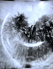 pinhole image of Copper House sculpture on fire