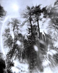 pinhole photo of copper house with fire inside